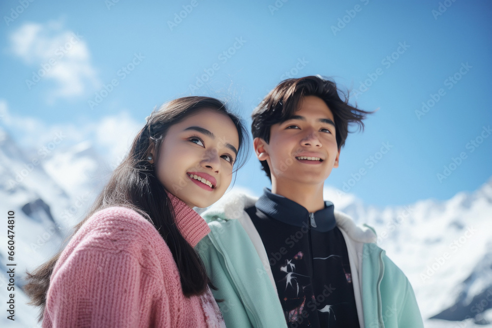 Young couple in warm wear, enjoying vacation at cold mountain Young couple in warm wear, enjoying vacation at cold mountain