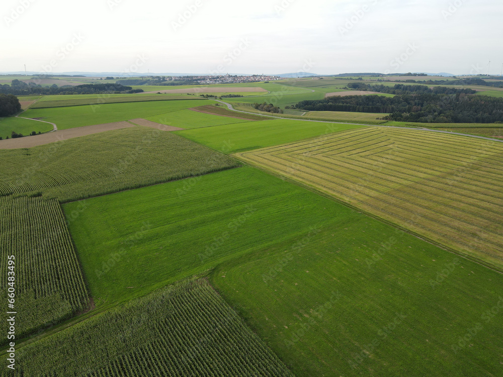Aerial view of mowed and harvested fields in the countryside in late summer 