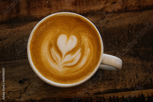 A cup of gourmet coffee on a wooden table
