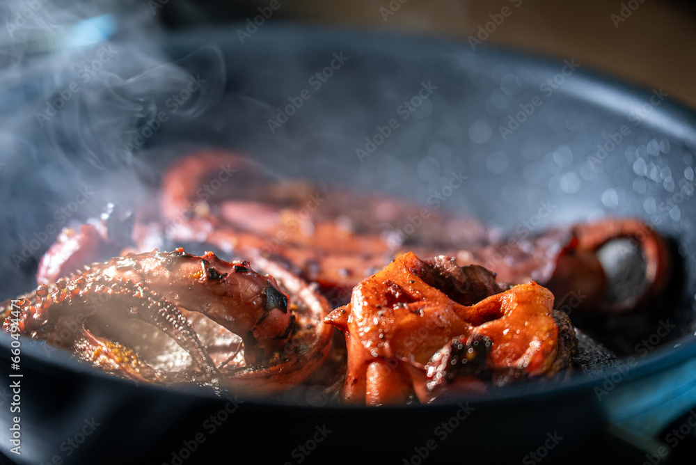 Cooking tentacles of octopus in frying pan. Cooking tentacles of octopus in frying pan.