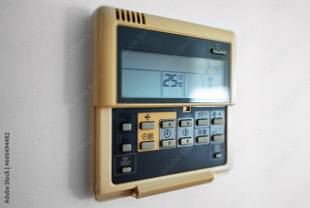 Close-up view of wall-mounted digital thermostat. Close-up view of wall-mounted digital thermostat.