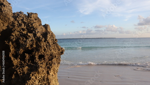 Kurkar sandstone formation close up blue sky background. Tanjung Bira white sand tourist beach