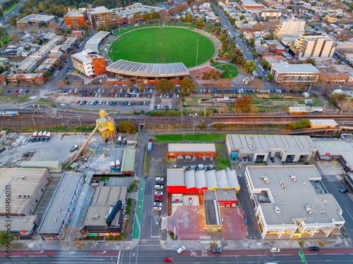 Aerial view of a railway line past a football stadium and commercial buildings photo