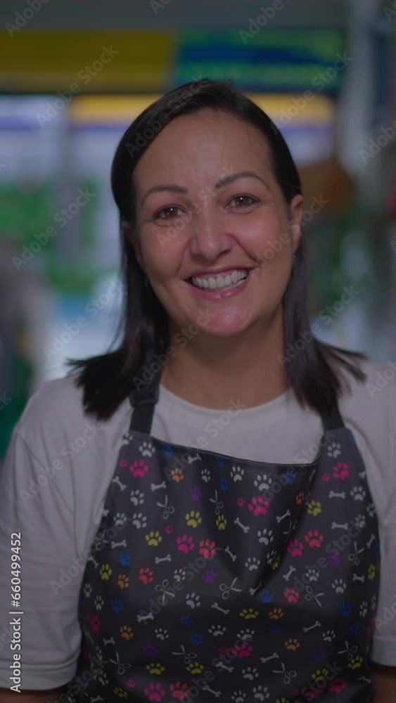 Happy Local Pet Shop Female Owner Portrait face close-up standing inside inside Store smiling. Woman wearing apron looking at camera in Vertical Video Happy Local Pet Shop Female Owner Portrait face close-up standing inside inside Store smiling. Woman wearing apron looking at camera in Vertical Video