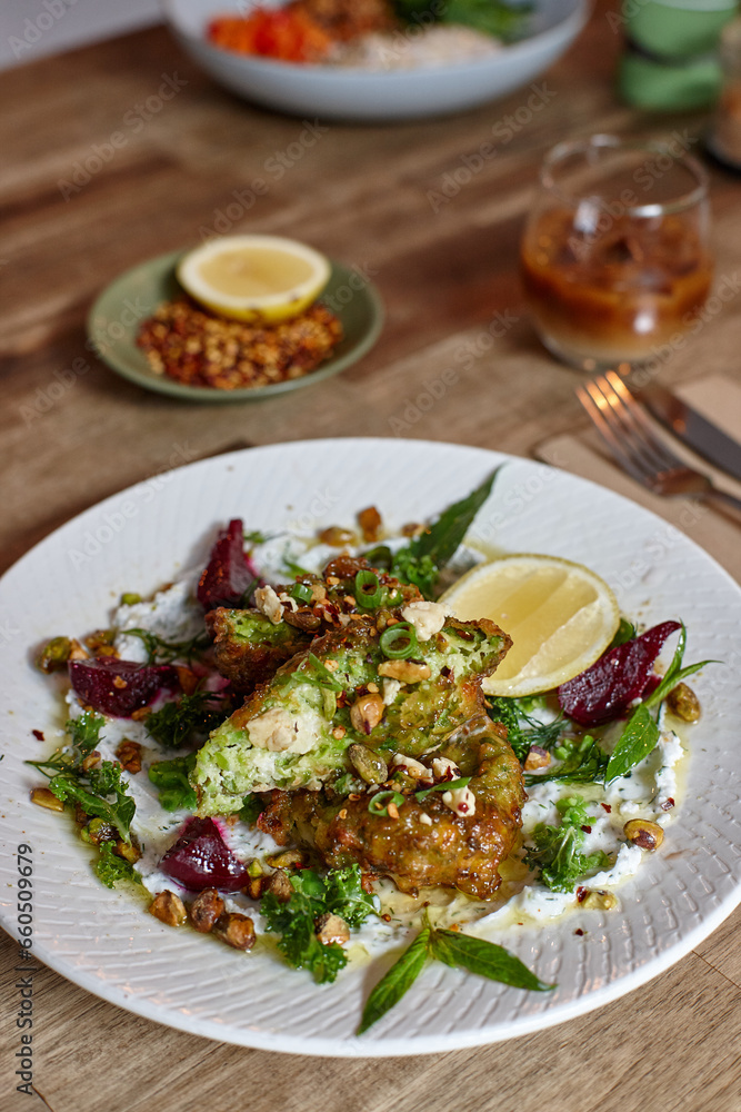 Healthy vegetarian falafel and salad dish on wooden table Healthy vegetarian falafel and salad dish on wooden table