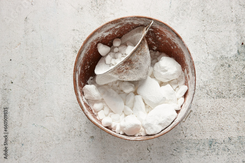 Bowl of lumpy icing sugar with sieve