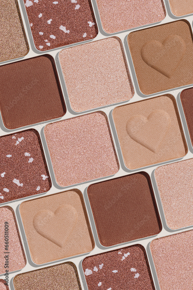 Fototapeta premium Minimal pattern of eye shadow beige tones swatches, monochrome photo background, eyeshadow with heart imprint, shiny natural shades powder makeup, square shape metal pack, beauty cosmetic texture