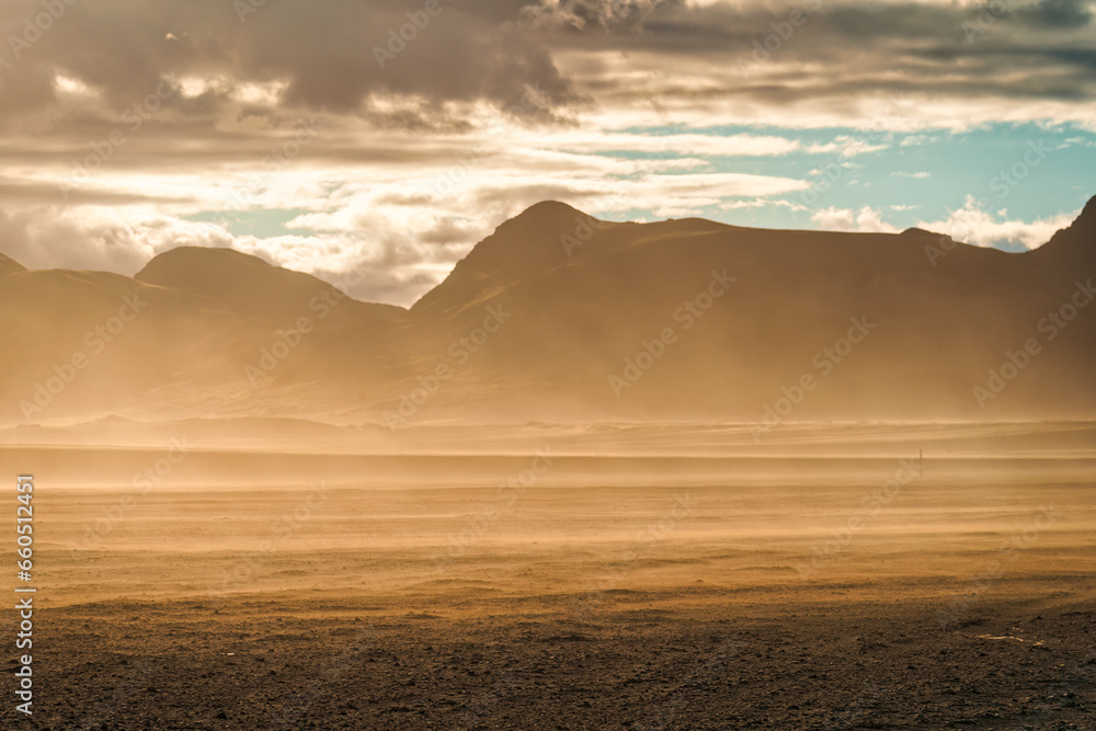 Landscape of sandstorm with sunlight blowing on volcanic wilderness in summer