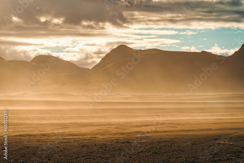 Landscape of sandstorm with sunlight blowing on volcanic wilderness in summer