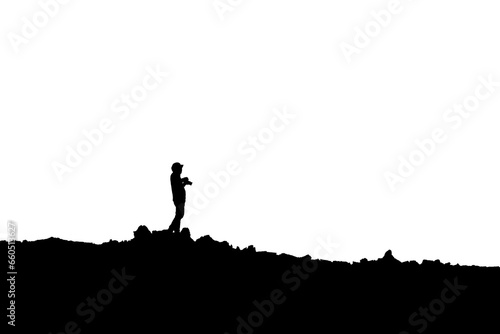 Silhouette of photographer standing with camera taking a photo on the mountain