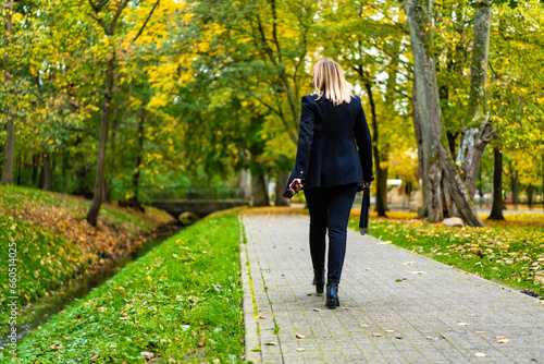 Beautiful businesswoman walking in city park  © Jacek Chabraszewski