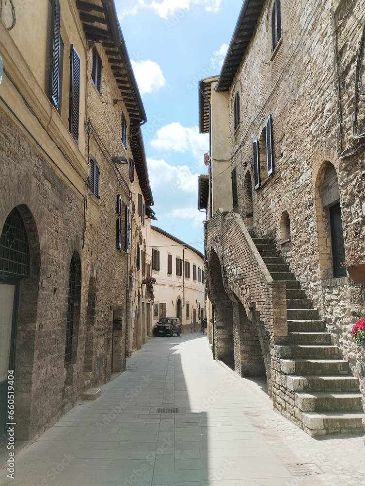 Discover a charming Umbrian village street with rustic stone houses. Capture timeless Italian charm.