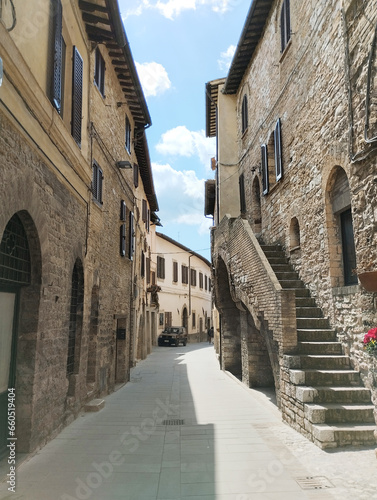 Fototapeta Naklejka Na Ścianę i Meble -  Discover a charming Umbrian village street with rustic stone houses. Capture timeless Italian charm.