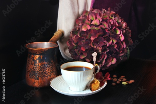 Close-up of coffee cup with flowers on table