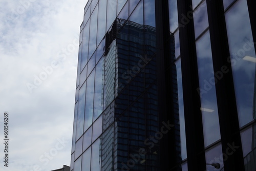 A reflection of a modern skyscraper in the glass