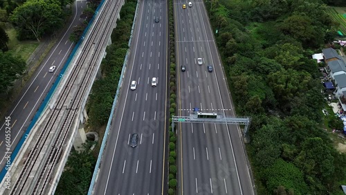 Aerial 4K Video view of cars passing on highways in Taiwan. Nearby is National Taipei University (NTPU) in Sanxia District in New Taipei City, Taiwan.  photo