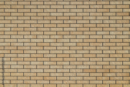 The texture of the stone. Ceramic tiles as a background. Brickwork made of artificial stone. Yellow brick wall. Tekxure brick wall background.