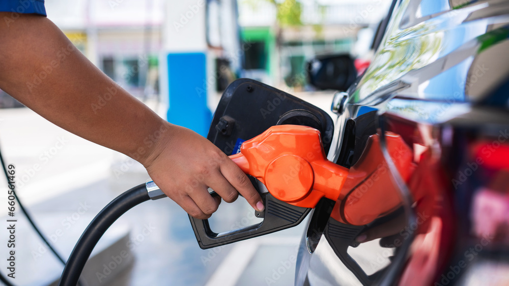 Gasoline being refilled at a petrol station. Refueling Diesel fuel is used to power a car.. Gasoline being refilled at a petrol station. Refueling Diesel fuel is used to power a car..