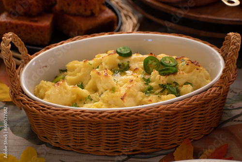 Vegan mashed poatoes as part of a plant-based Thanksgiving table setting, served in vintage ceramic and  wicker woven basket photo