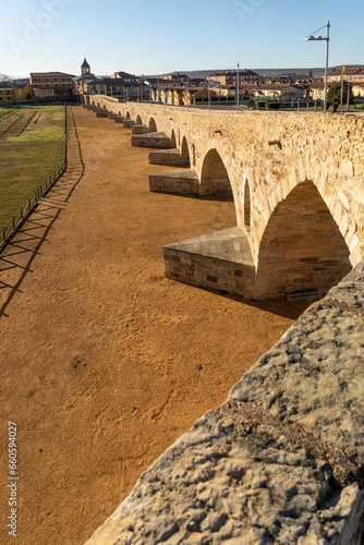 Passo Honroso bridge of the village of Hospital de Órbigo in the Camino de Santiago (Way of Santiago) at sunset, León, Spain photo