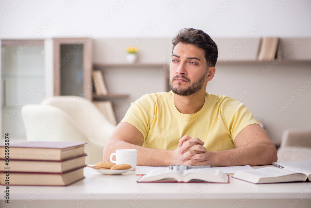 Young male student studying at home Young male student studying at home