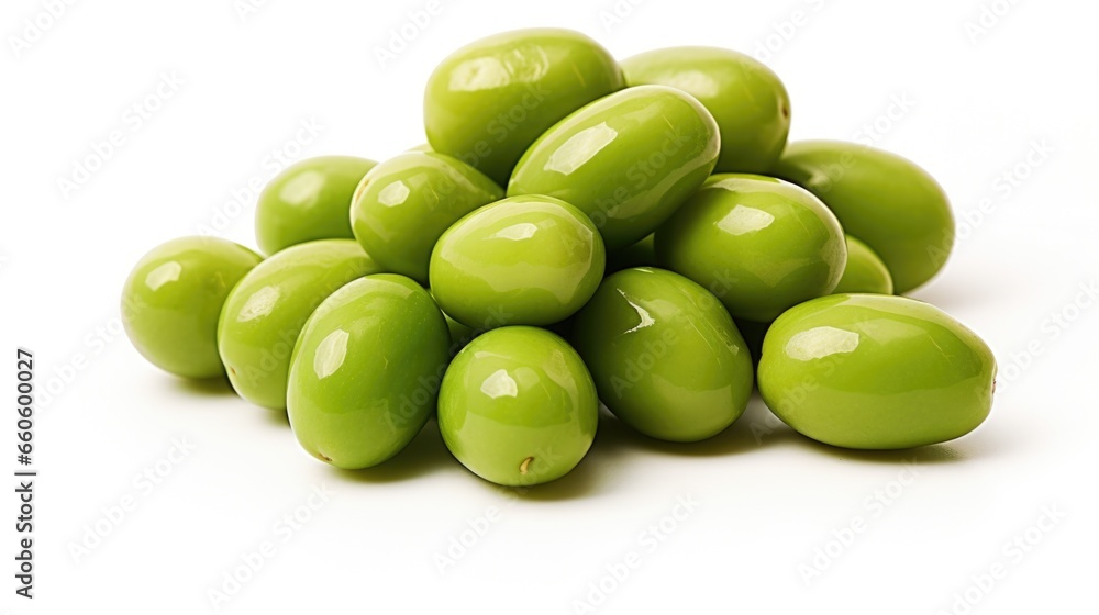 A pile of green olives on a white surface A pile of green olives on a white surface