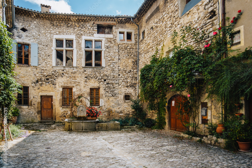 Old stone house facades on the Place de la Concorde in the medieval village of Chatillon en Diois, in the south of France (Drome)