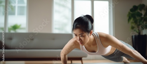 Young Asian woman doing push-ups for health indoors