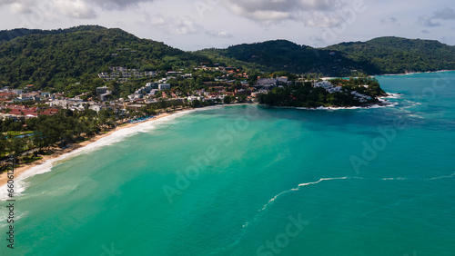 Beautiful beach with colorful water. Top view of the beautiful coastline. Sunny summer day. Colorful water. Sandy beach. 