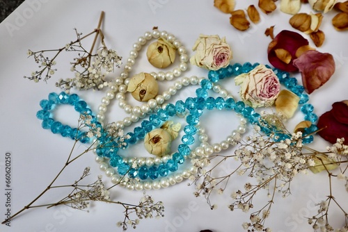 White and blue beads with dried rose buds