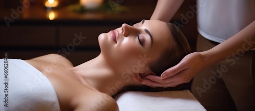 Young beautiful woman doing facial massage