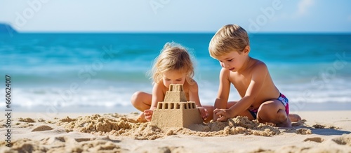 two small children playing in the sand on the beach