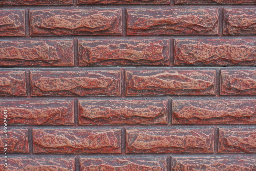 Fototapeta premium horizontal brown decorative smooth modern brick-shaped fence texture with concrete on the street