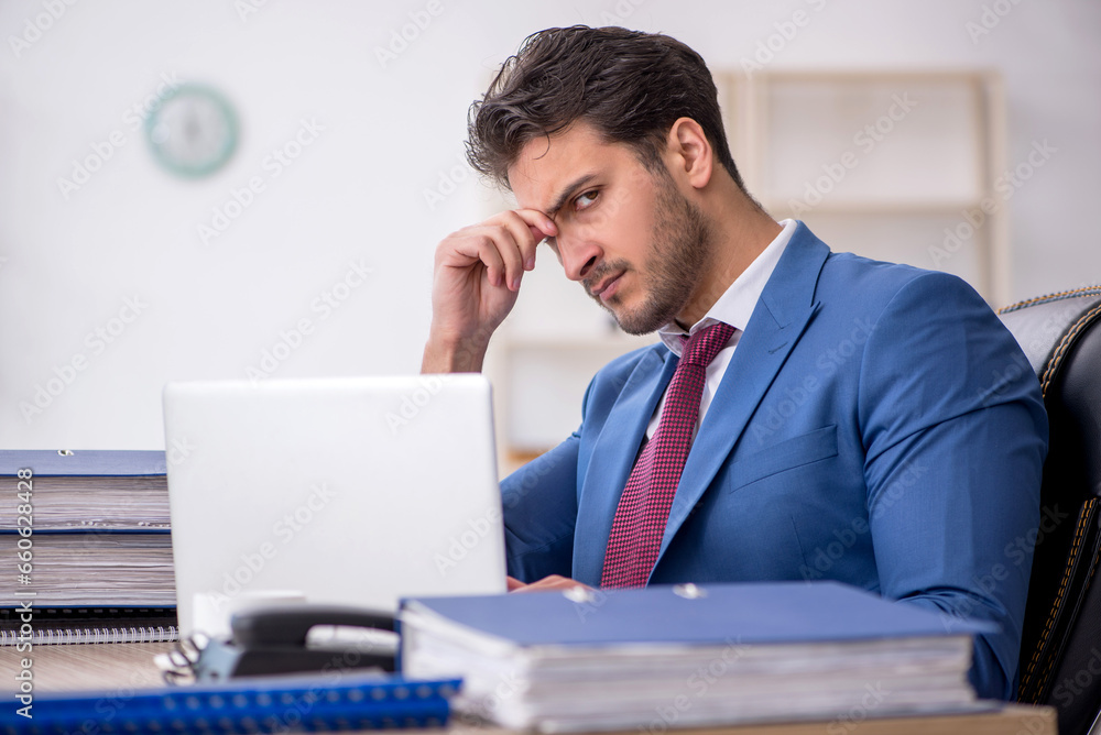 Young male employee working in the office Young male employee working in the office