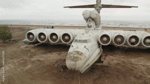 Derbent, Dagestan, December 07, 2022: Aerial view of a military aircraft ekranoplan Lun on the seashore of the Caspian Sea. Soviet military aircraft. Detailed shooting. photo