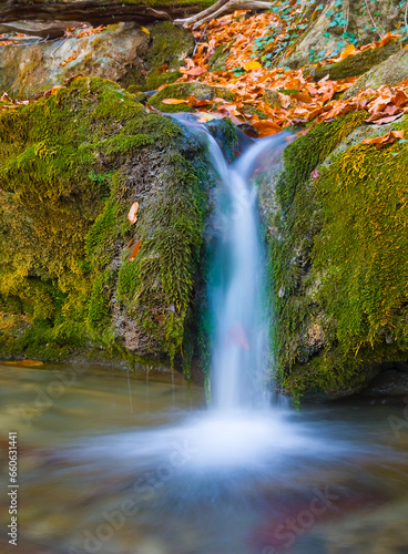 closeup small brook with waterfall rushing in mountain canyon among a stones © Yuriy Kulik