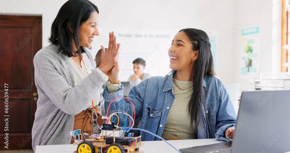 Fototapeta premium Learning, teacher and high five of student on laptop in classroom, achievement or goal in robotics. Engineering, computer and teenager celebrate success, happy girl and study education at high school