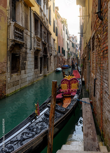 Narrow canal with gondola in Venice  Italy. Architecture and landmark of Venice. Cozy cityscape of Venice.
