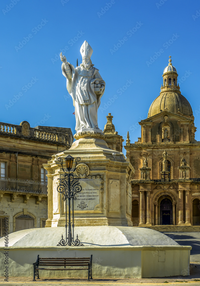 Statue of St. Nicholas in front of the Parish Church of San Nicholas, Siggiewi, Malta. Vertical.