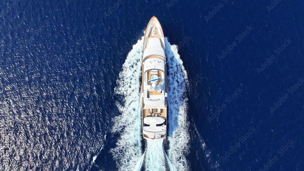 Aerial drone photo of latest technology yacht cruising near famous beach of Super paradise, Mykonos island, Cyclades, Aegean sea, Greece - obrazy, fototapety, plakaty 
