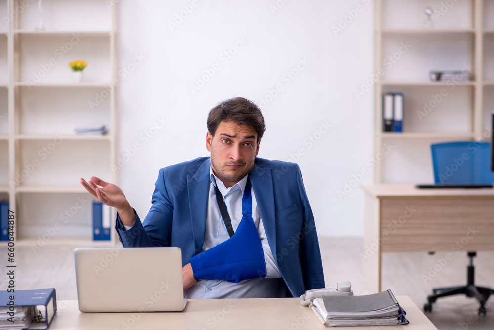 Young male employee after car accident at workplace Young male employee after car accident at workplace