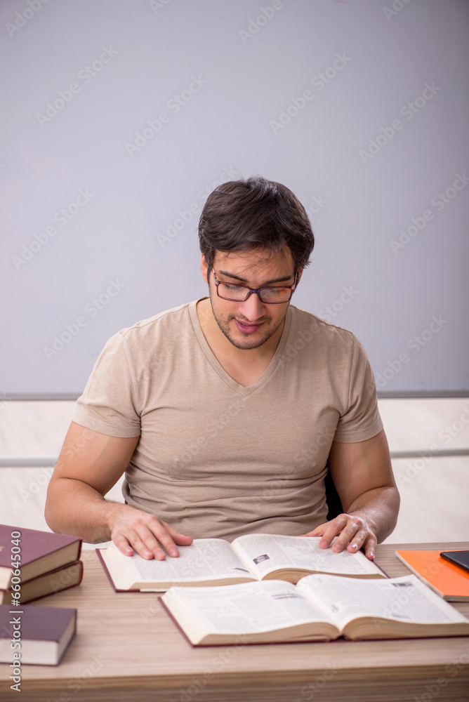 Young male student sitting in the classroom Young male student sitting in the classroom