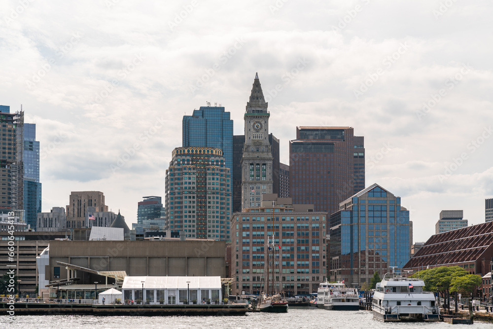 Panoramic city view of Boston from Harbour area at day time, Massachusetts. An intellectual, technological and political center. Building exteriors. Panoramic city view of Boston from Harbour area at day time, Massachusetts. An intellectual, technological and political center. Building exteriors.