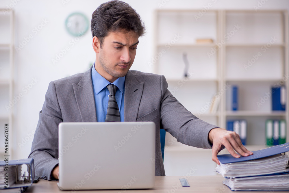 Young male employee working in the office Young male employee working in the office