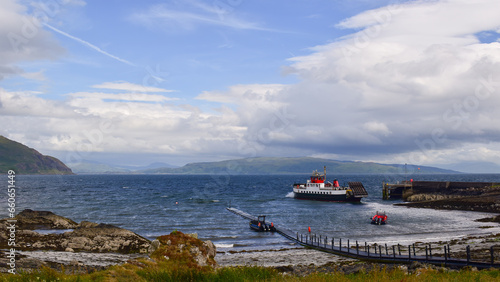 Ferry boat leaving small port while retracting roro ramp
