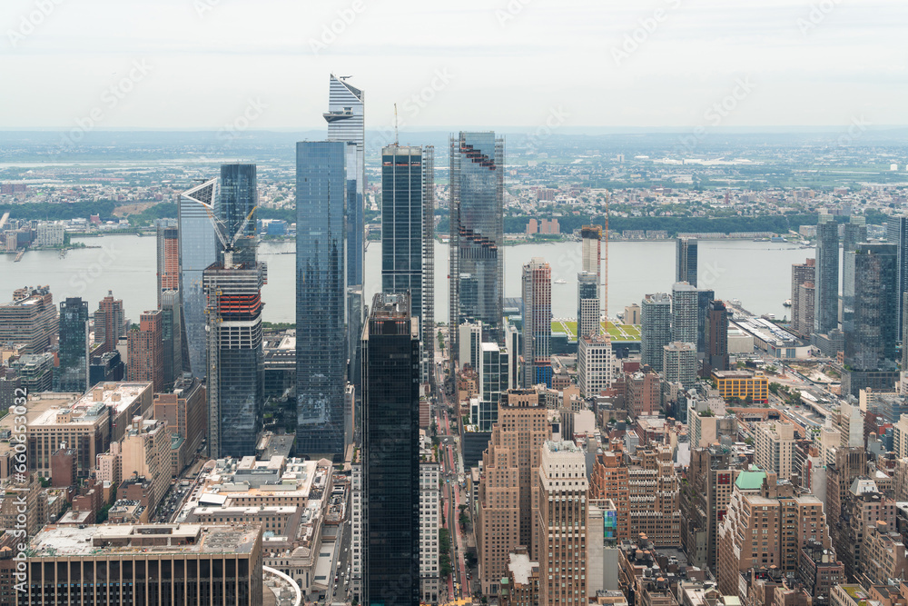 Aerial panoramic city view of West Side Manhattan and Hudson Yards district at day time, NYC, USA. New Jersey on horizon over the Hudson River. A vibrant business neighborhoods.