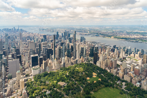 Aerial panoramic city view of Midtown Manhattan neighborhoods towards lower Manhattan and Downtown, Central Park on bottom, New York City. Bird's eye view from helicopter of metropolis cityscape