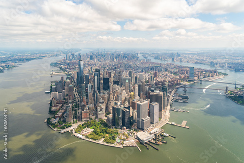 Aerial panoramic city view on Lower Manhattan district and financial Downtown  New York City  USA. Bird s eye view from helicopter. A vibrant business neighborhood. Hudson River and East River.