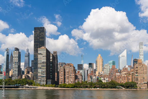 New York City skyline from Roosevelt island over the East river towards the skyscrapers of Manhattan Midtown at day time, NYC, USA. A vibrant business neighborhood