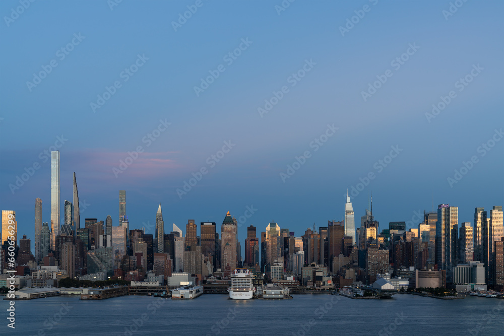 Aerial New York City skyline from New Jersey over the Hudson River with the skyscrapers at night. Manhattan, Midtown, NYC, USA. A vibrant business neighborhood